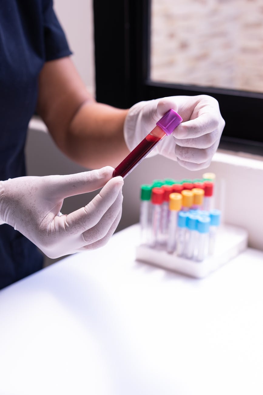 person holding a blood sample in a test tube